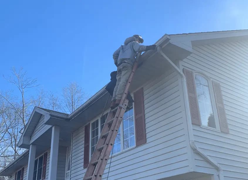 Gutter cleaning and maintenance being performed by Painesville Power Washing in Painesville