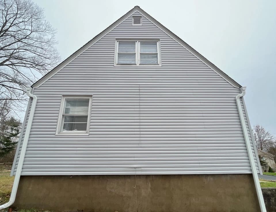 Painesville Power Washing technician performing detailed house washing in Painesville residential area